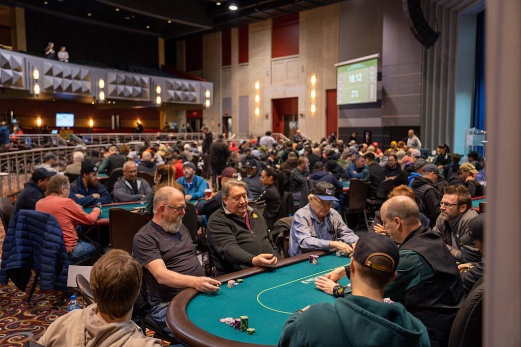 Poker players seated around a tournament table